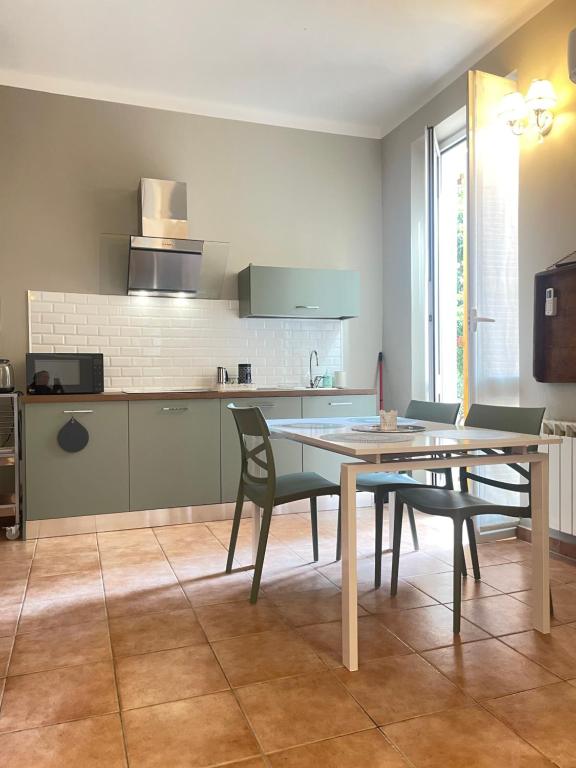 a kitchen with a table and chairs in a room at CASA FRE genova in Genova