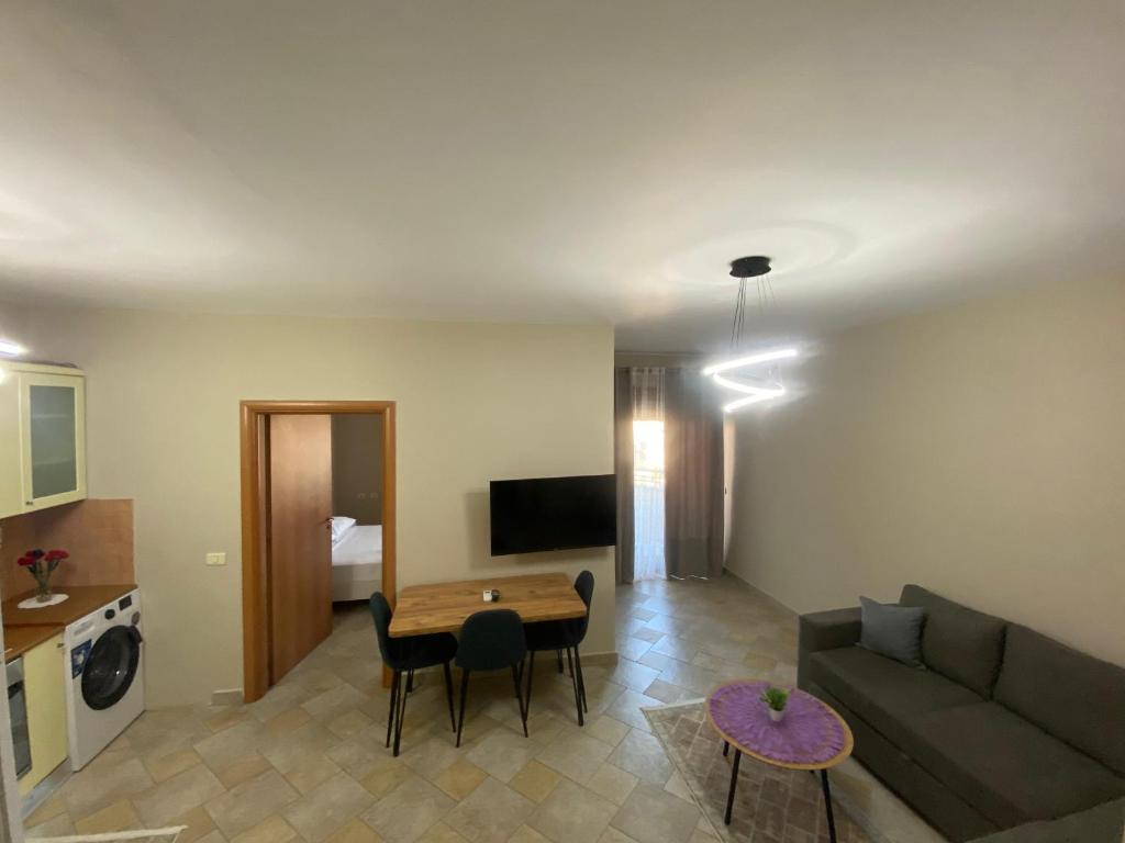 a living room with a couch and a table at Sunor Apartments - City Center in Tirana