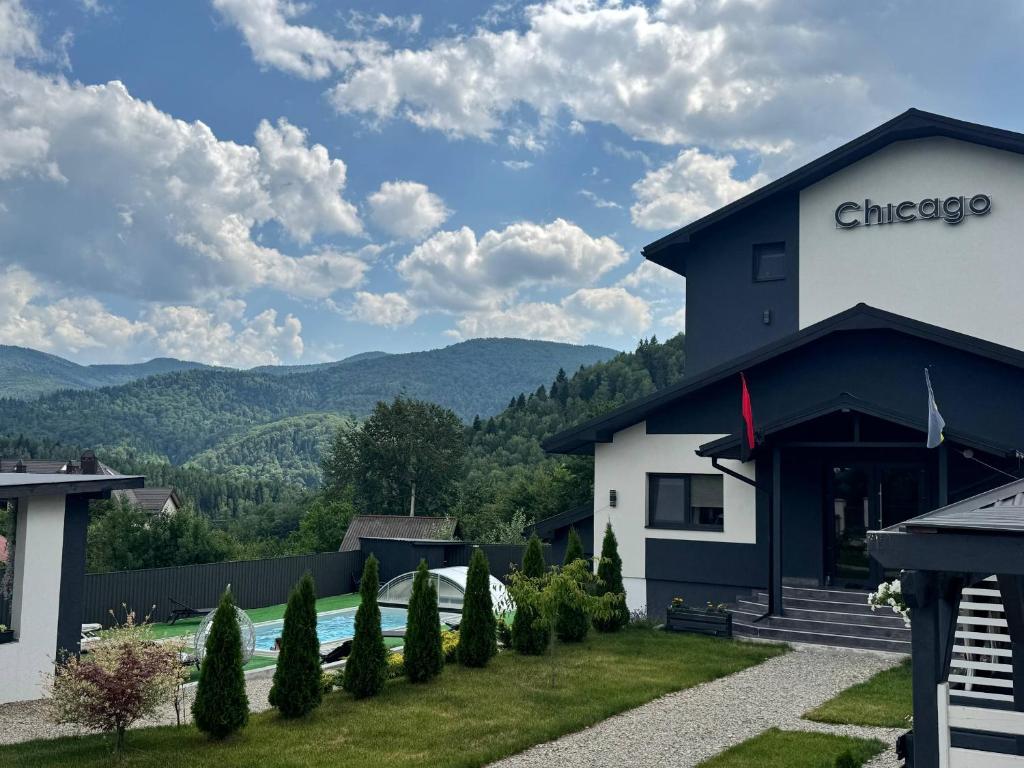 a building with a view of the mountains at Chicago Hotel in Yaremche