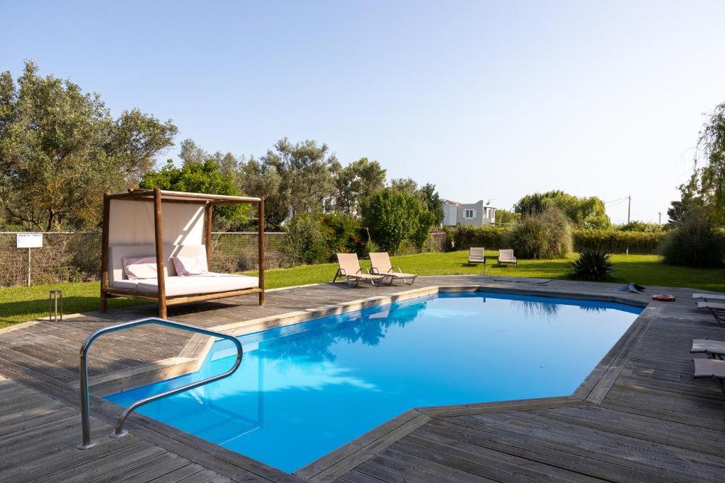 a large swimming pool with a gazebo next to a yard at Gyra Villas - Villa Ermis with private pool in Lefkada