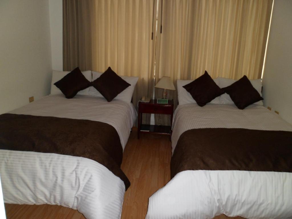Postel nebo postele na pokoji v ubytování Hotel Tuvalu