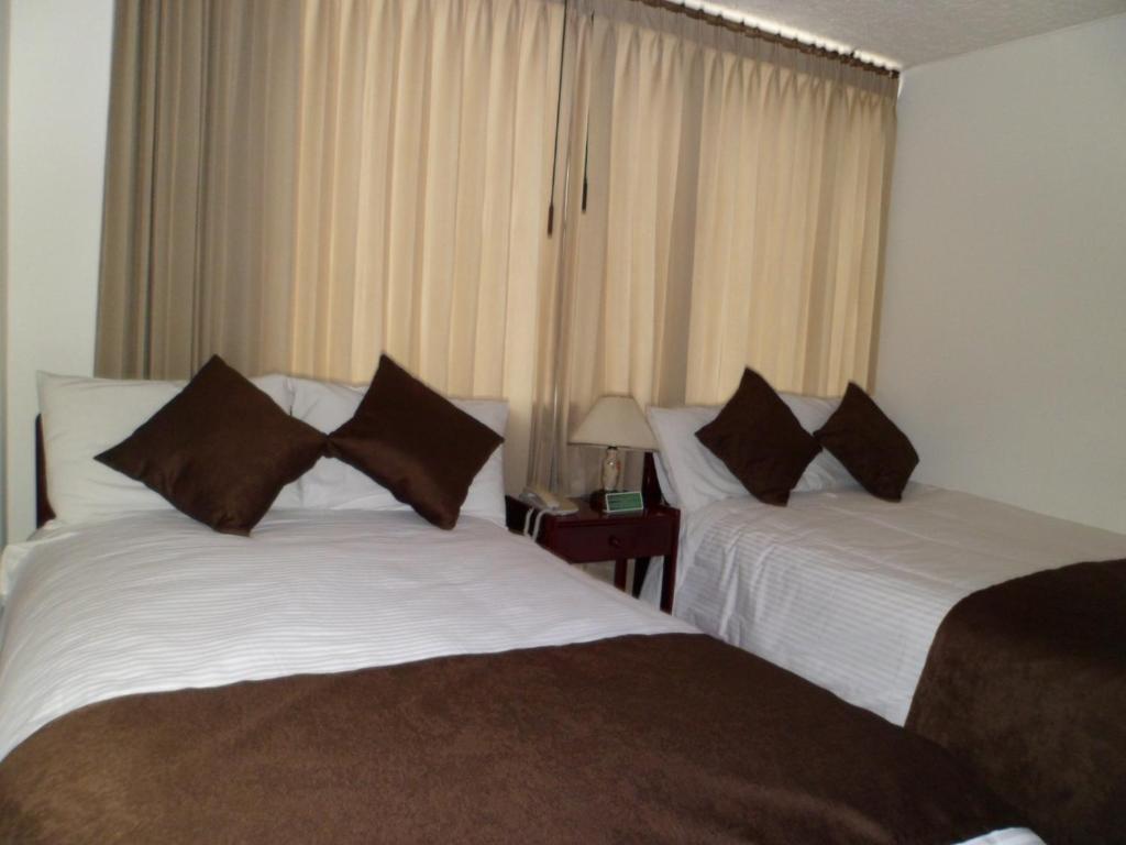 Postel nebo postele na pokoji v ubytování Hotel Tuvalu