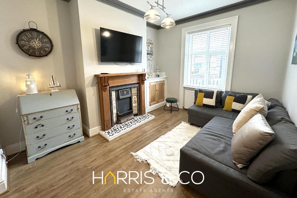 a living room with a couch and a fireplace at Admirals Rest in Fleetwood