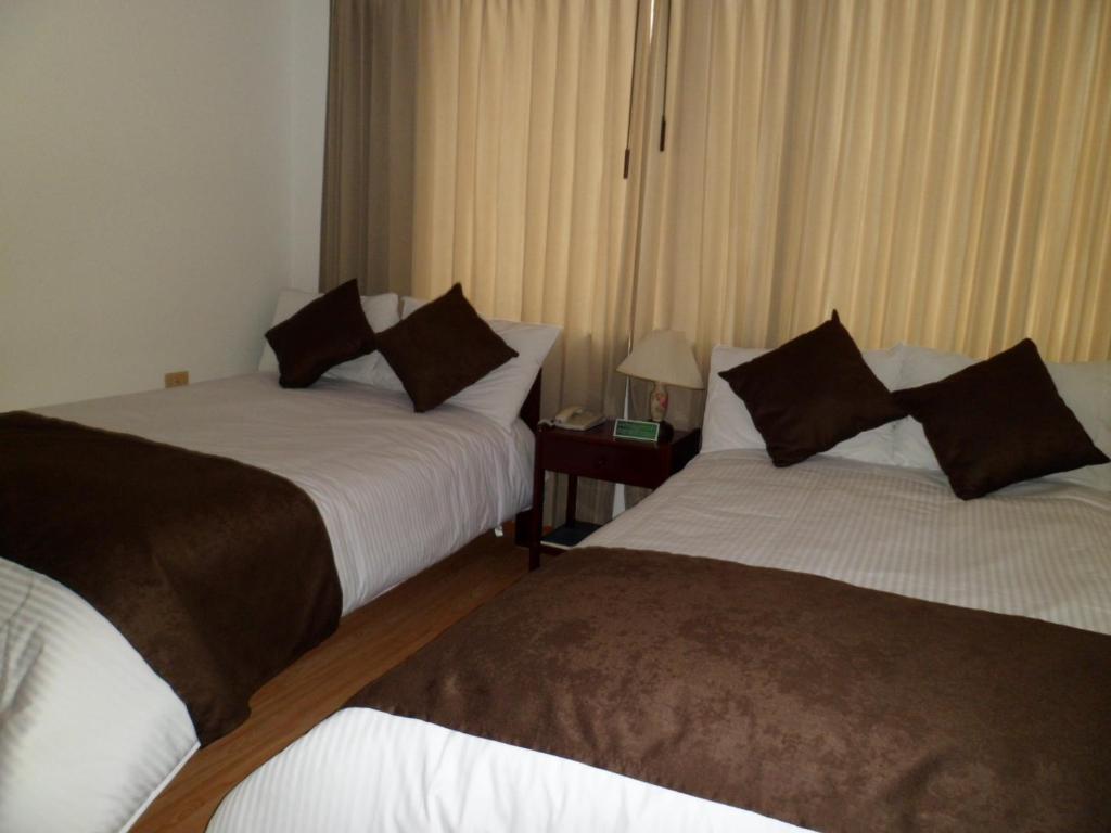 Postel nebo postele na pokoji v ubytování Hotel Tuvalu