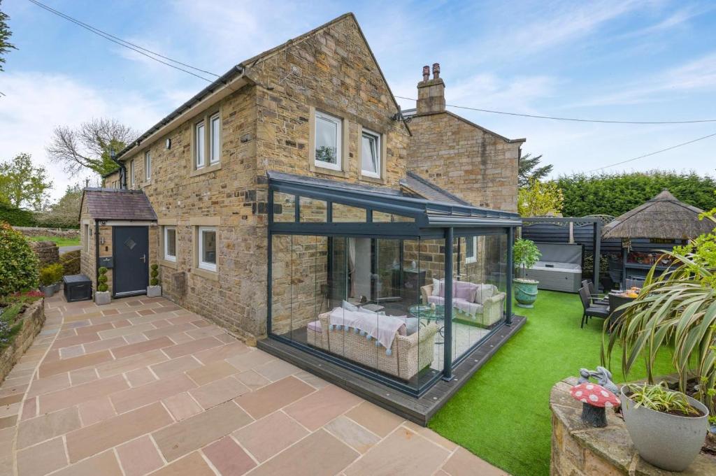 an internal view of a house with a glass extension at Johns Cottage in Hampsthwaite