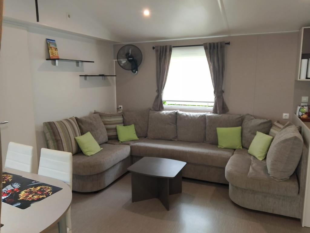 a living room with a couch and a table at Domaine De Dugny in Veuzain-sur-Loire