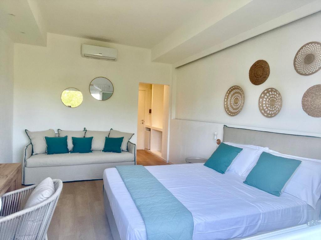a bedroom with a large bed and a couch at Elis rooms & suite in Olbia