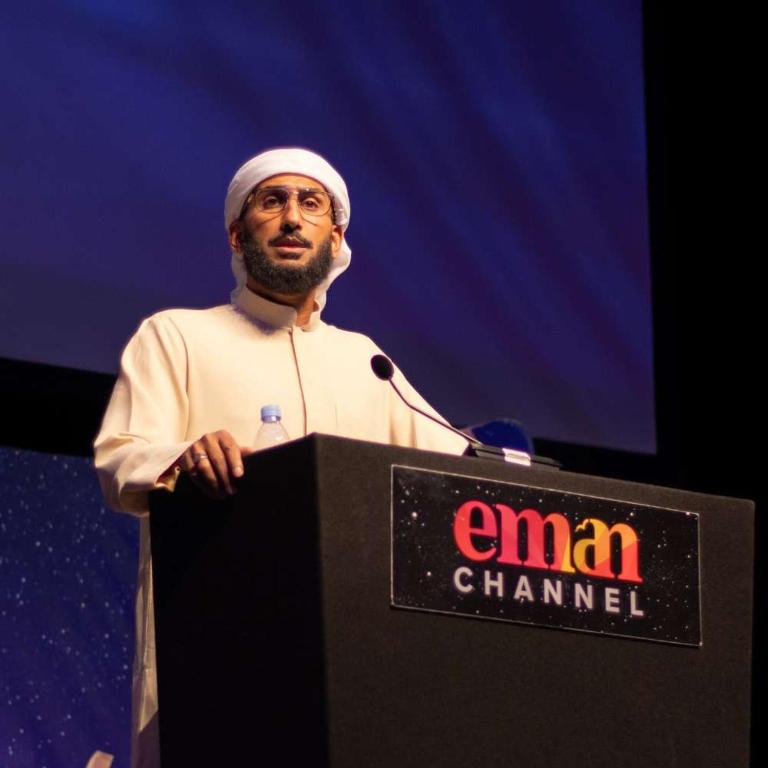 a man standing at a podium in front of a microphone at Flex in Mekhrably