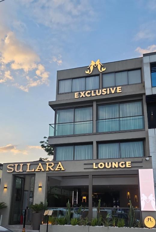 a building with a sign on top of it at Sulara Exclusıve Hotel Lounge Bistro in Antalya