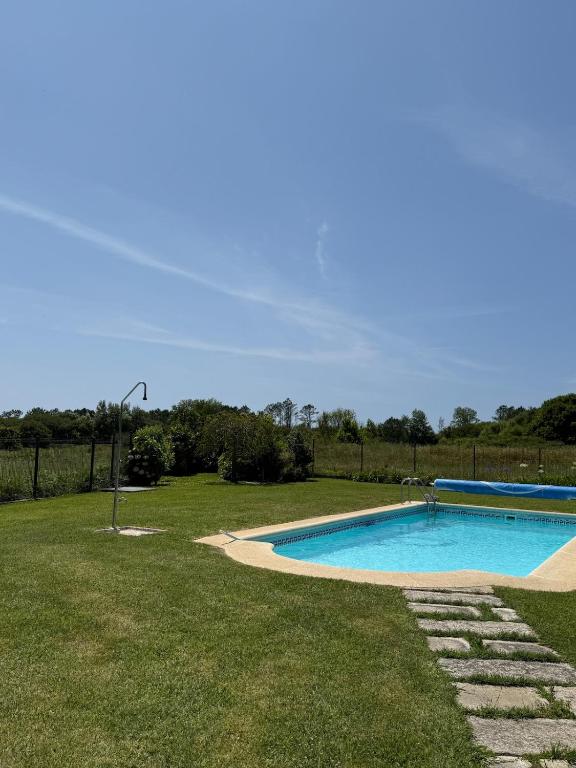 a swimming pool in the middle of a yard at Villa Atlántica in Ribeira