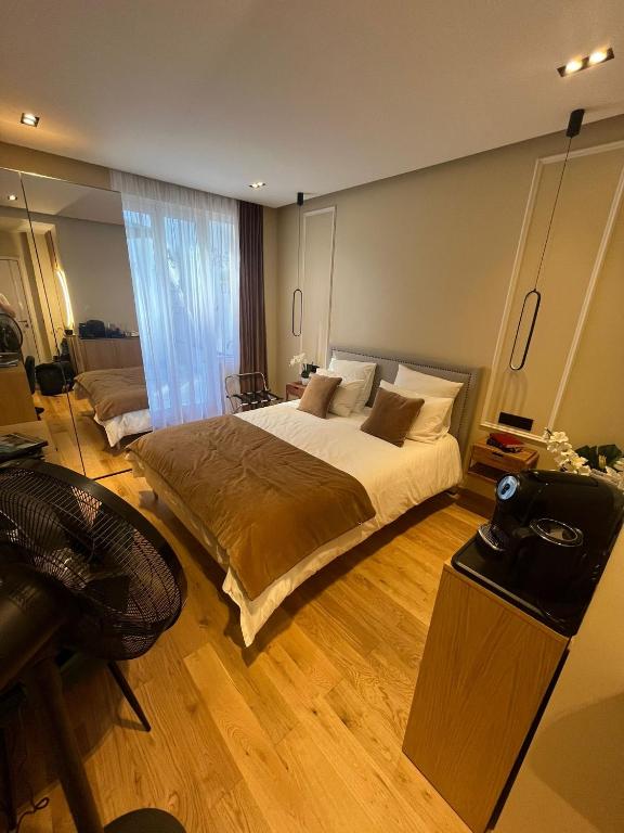 une grande chambre avec un grand lit et un bureau dans l'établissement La Suite Parisienne, à Paris