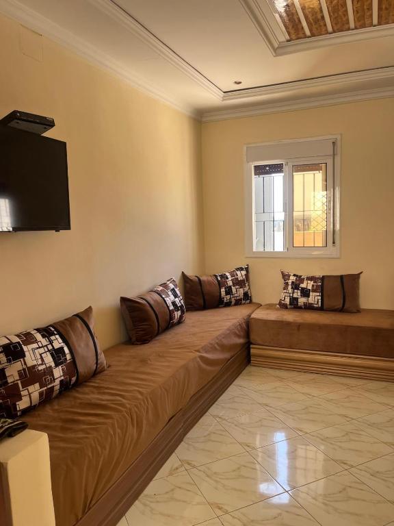 a living room with a couch and a television at 3 Chaaban 1, 1136 in Larache