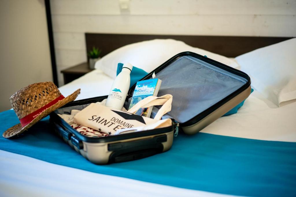 a suitcase sitting on top of a bed at Domaine Saint Estève in Millau