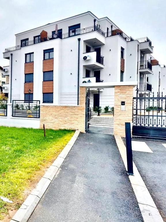 a large white building with balconies on it at Apartman Lena in Vrnjačka Banja