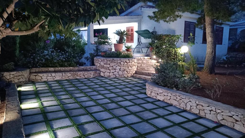 a walkway in front of a house at night at Casa Vacanze Maria in San Vito lo Capo