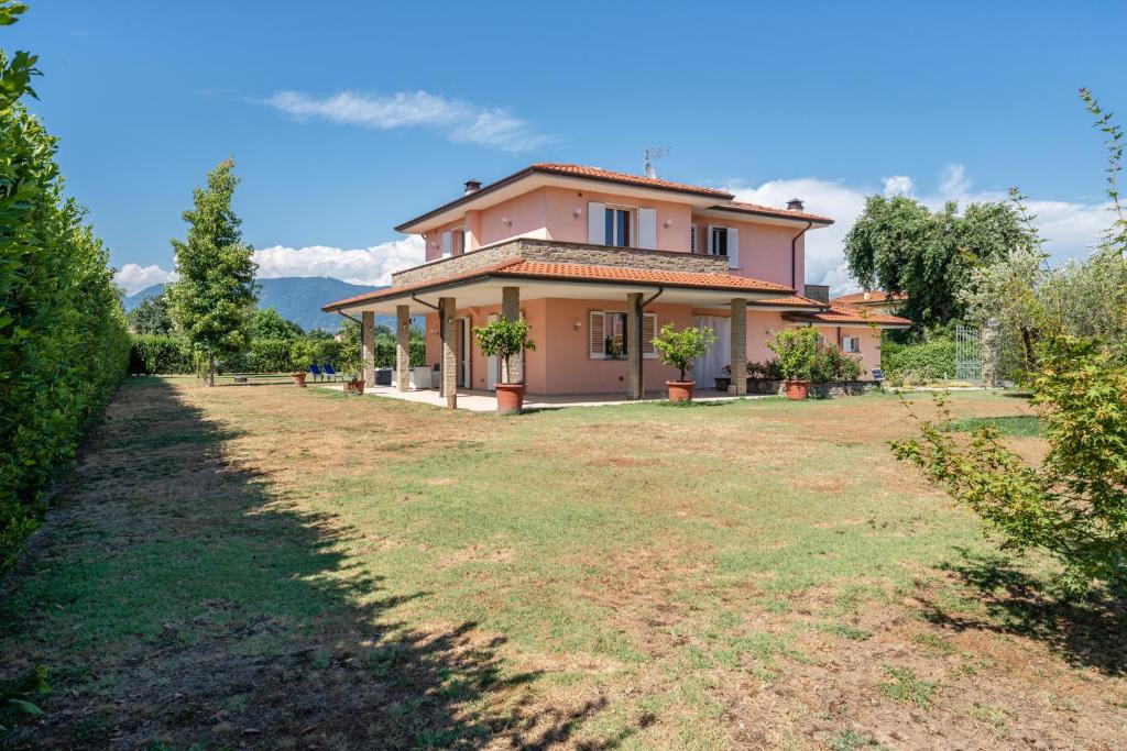 a house with a large yard in front of it at Villa Angela in Capannori