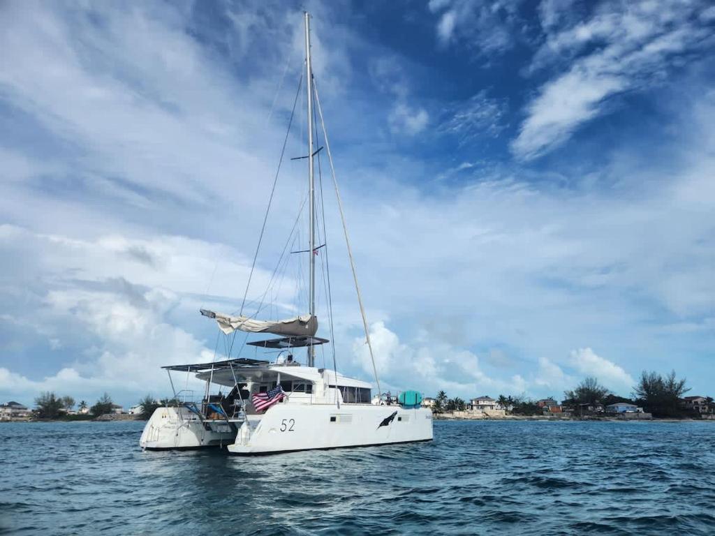 a white boat in the water under a cloudy sky at Spacious 52 ft Catamaran for Dockside Stay in Key West
