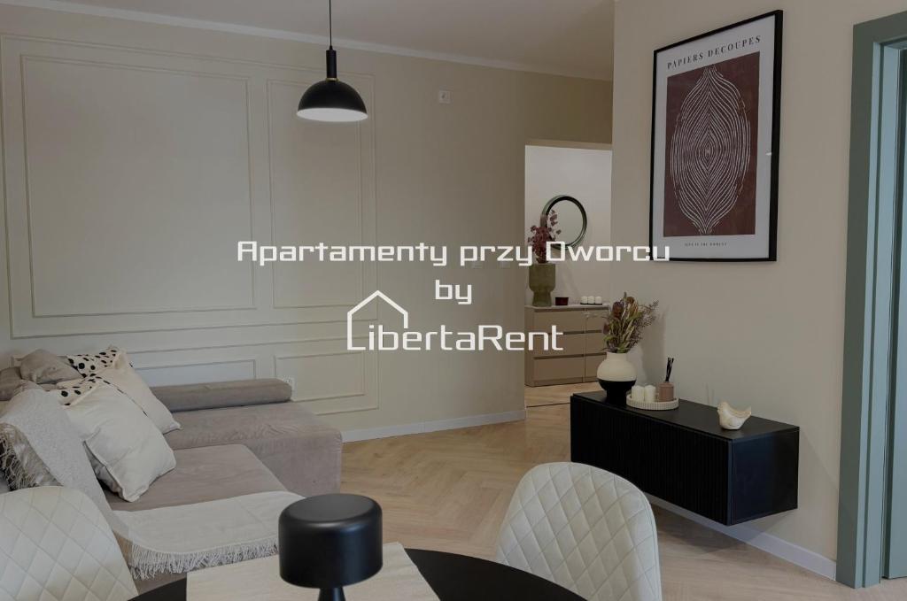 a living room with a couch and a table at Apartamenty przy Dworcu by LibertaRent in Wałbrzych