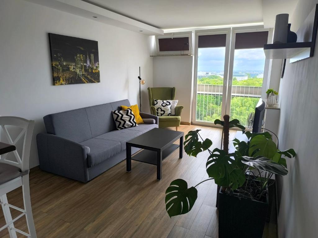 a living room with a couch and a table at Downtown Apartment in Warsaw