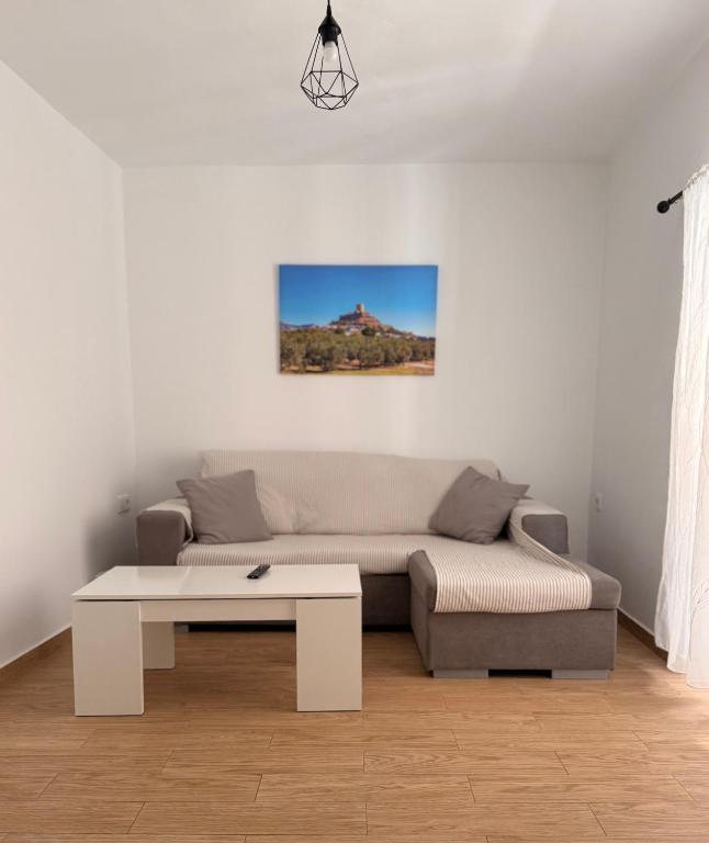 a living room with a couch and a coffee table at El Olivo in Alcaudete