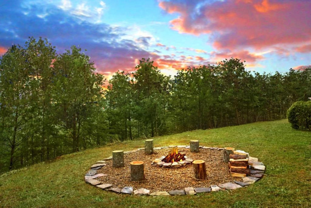 a fire pit in the middle of a field at Heavenly Heights Holiday home in Gatlinburg