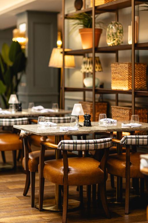 a restaurant with wooden tables and chairs and shelves at Mount Errigal Hotel, Conference & Leisure Centre in Letterkenny