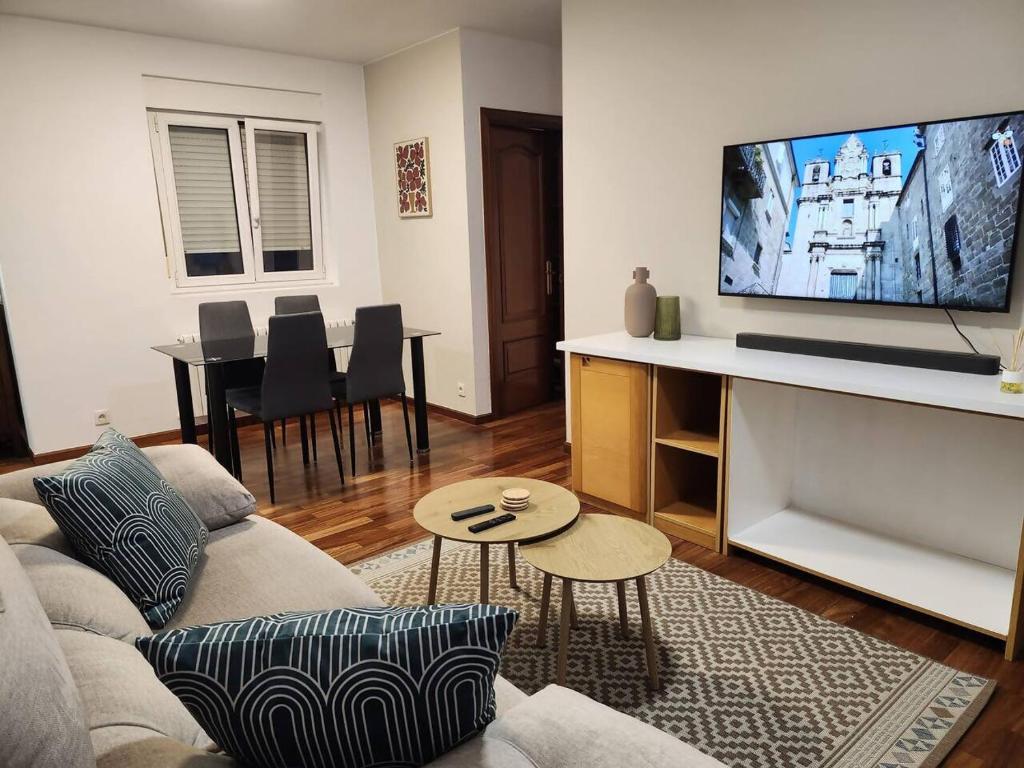 a living room with a couch and a flat screen tv at Apto Carballo - NETFLIX y calefacción in Carballo
