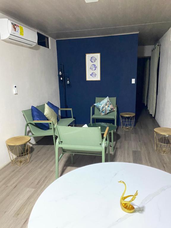 a room with blue walls and chairs and a table at Coral Stay Bahia Drake in Drake