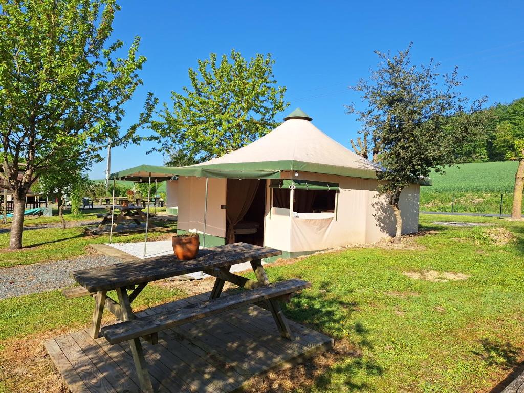 a picnic table in front of a gazebo at Les 2 étangs La Foulonnerie Lodge - Tente in Saint-Jean-Saint-Germain