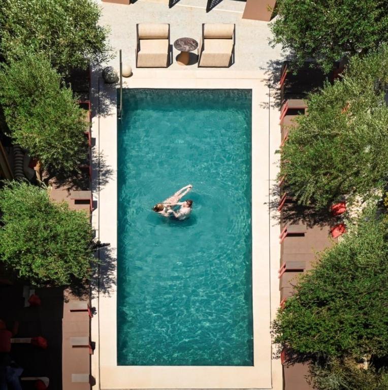 a person in a boat in a large pool of water at Ikaros Suites in Amoudara Herakliou