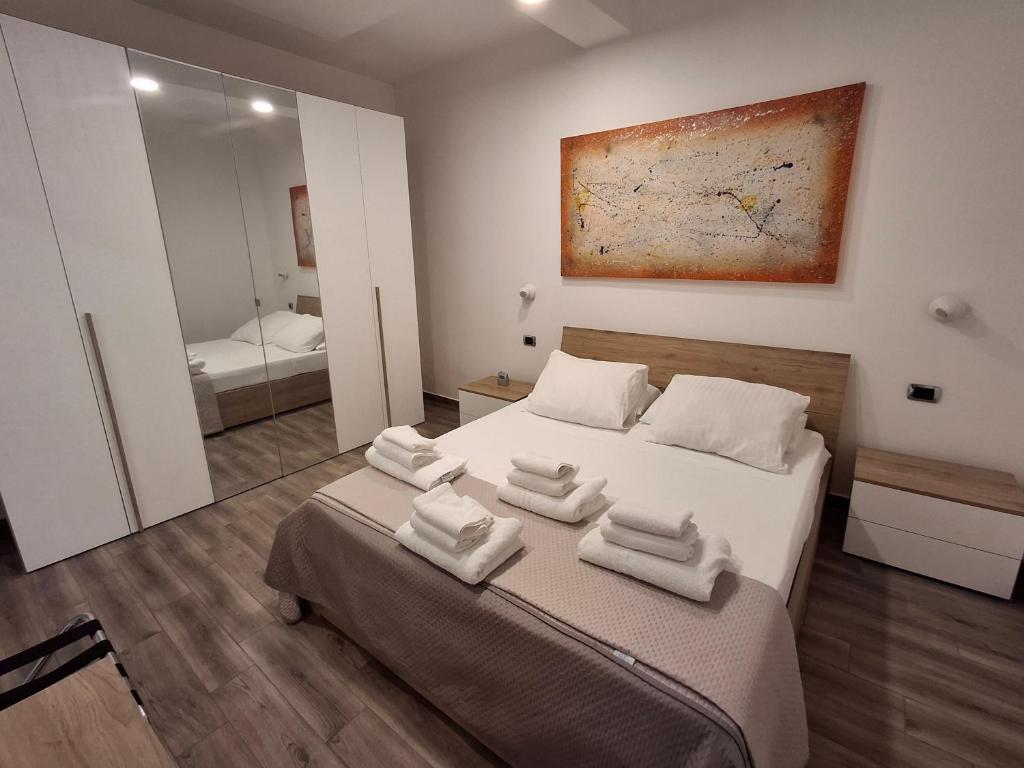 a bedroom with a bed with white towels on it at Imperial Apartment in Rome