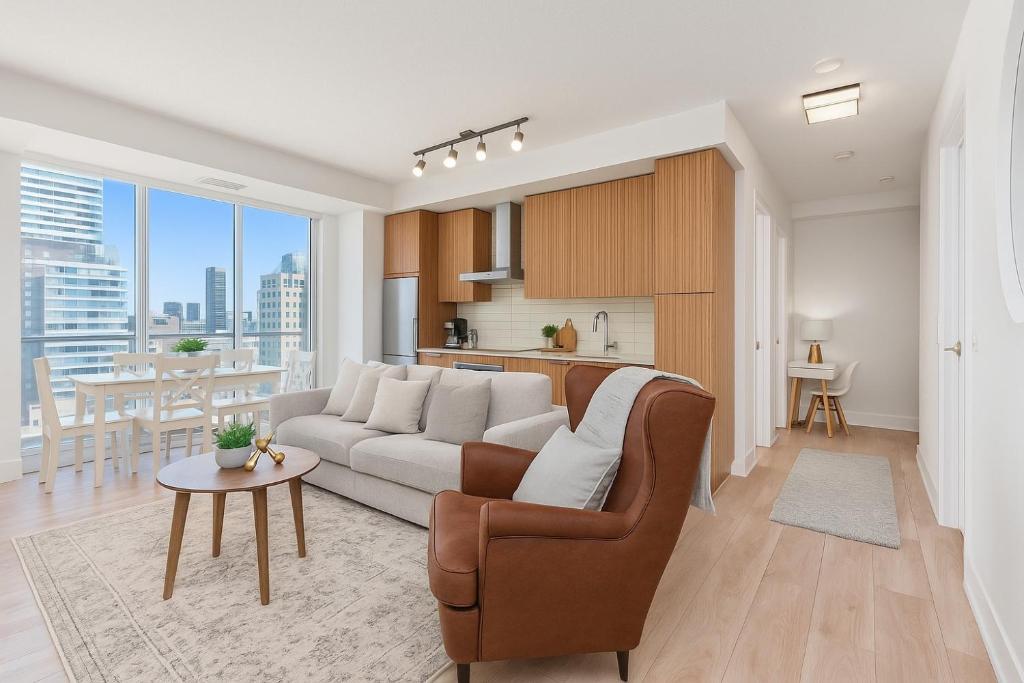 a living room with a couch and a table at Belarte Suites - Downtown Toronto - CN Tower & Rogers Centre in Toronto