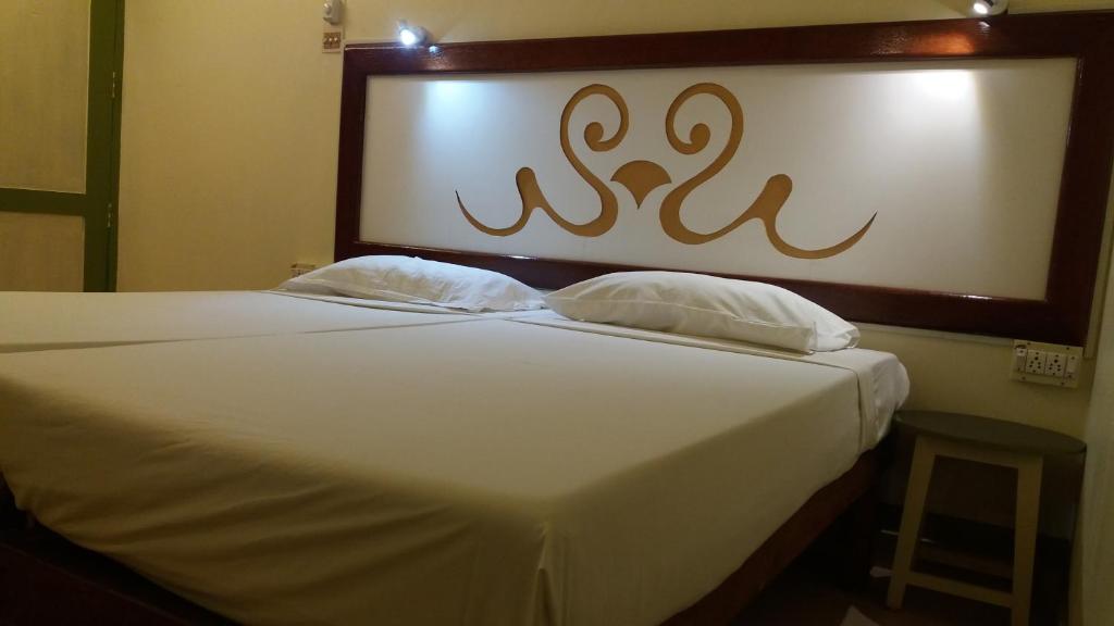 Ένα ή περισσότερα κρεβάτια σε δωμάτιο στο Johny's Beach House Kovalam