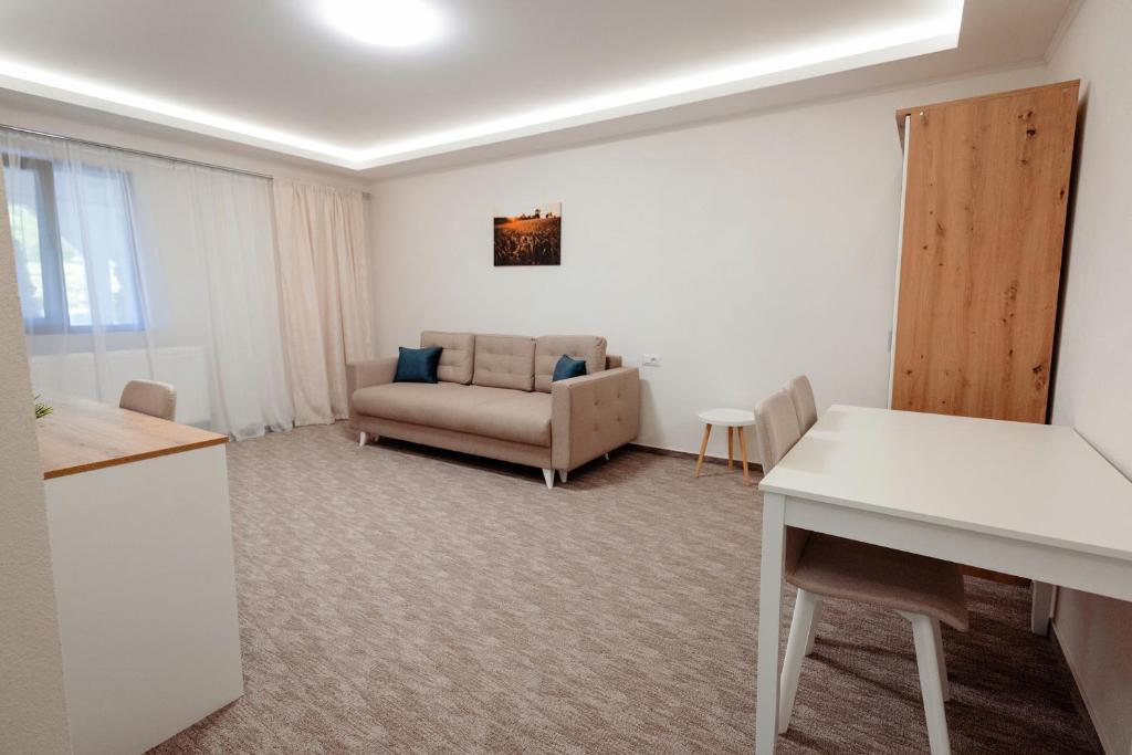 a living room with a couch and a table at Casa Vlad in Tisa