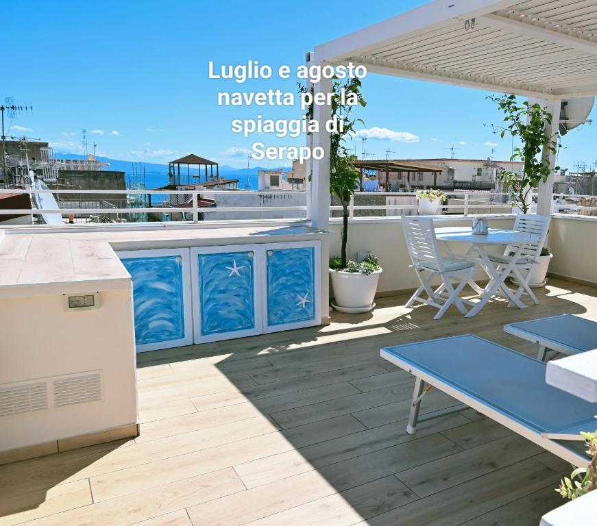 a patio with a table and chairs on a balcony at The Sorabellas in Gaeta