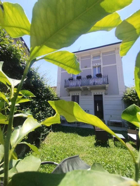 a house with a balcony in the back yard at Villa Martina Luxury Suites Como Lake in Lecco
