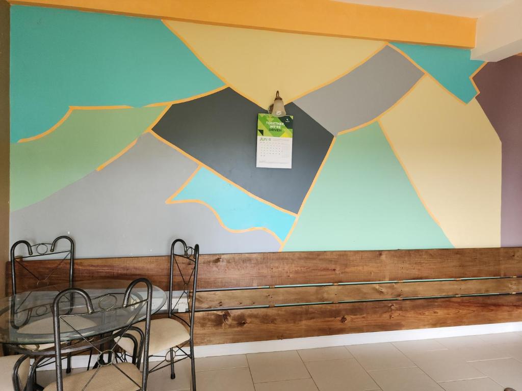a dining room with a mural on the wall at Nia's Hillside Apartment - Amazing Scenery in Grande Rivière