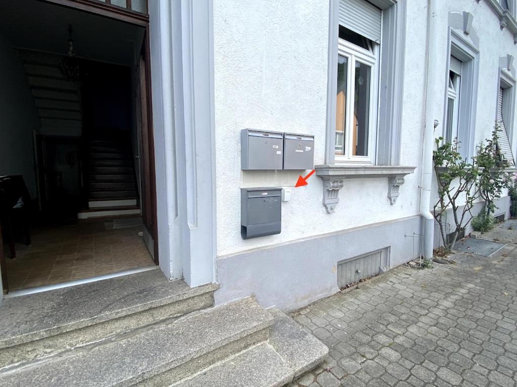 a box on the side of a building with a window at Basseltang urban apartment in Grenzach-Wyhlen