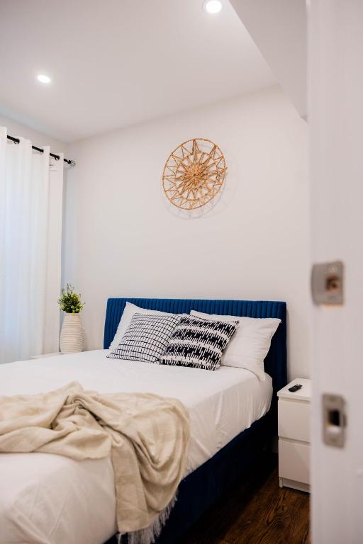 a bedroom with a bed with a clock on the wall at Joynest Place in Newark