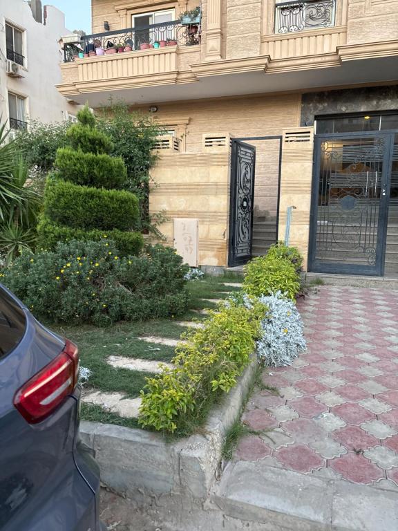 a building with a door and a balcony with flowers at Zayed hotel in Sheikh Zayed