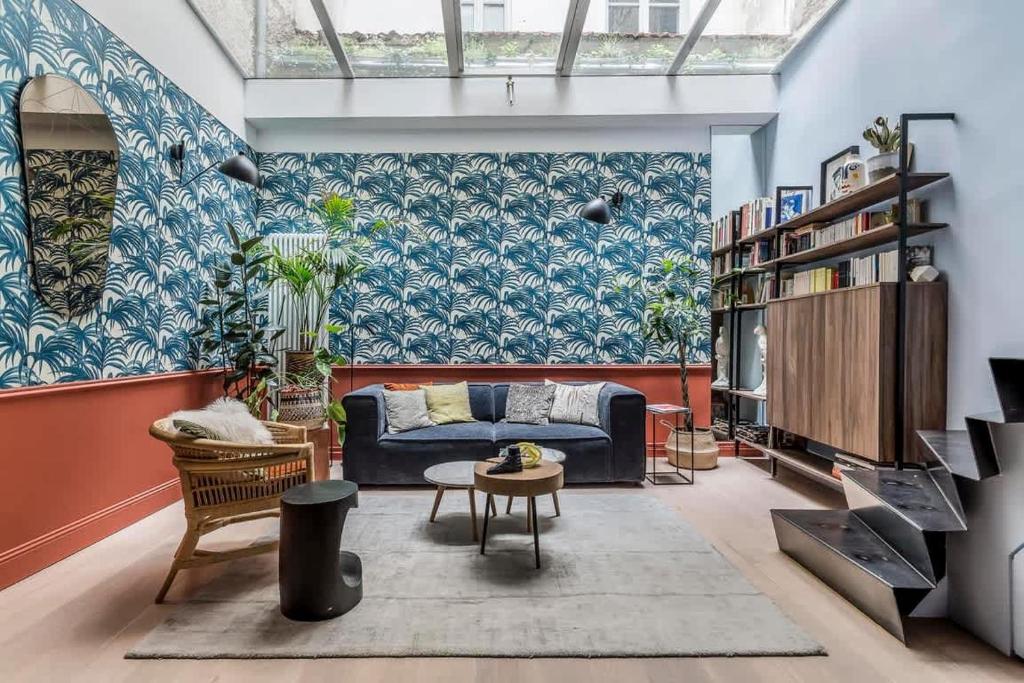 a living room with a couch and a table at Jungle Art - Furnished apartment - Downtown Lyon in Lyon