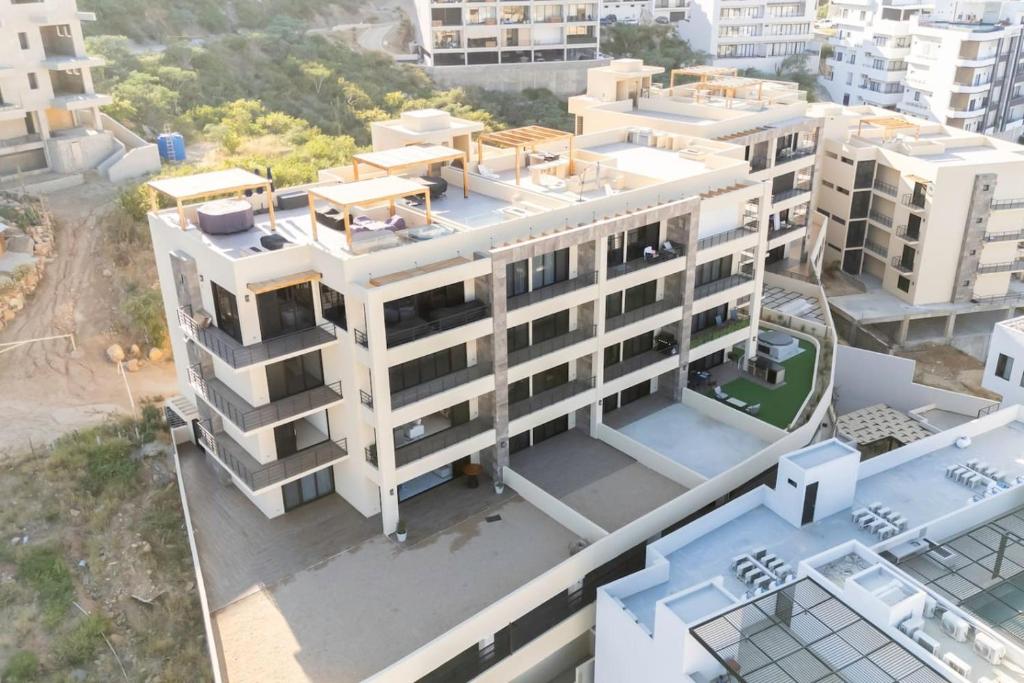 an overhead view of a large white building at New 3 BD Condo with Pool and Gym in Cabo San Lucas
