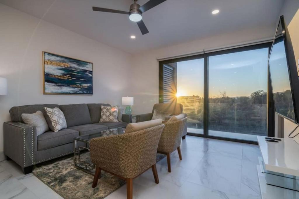 a living room with a couch and chairs at Find peace in this 2 BD condo in Cabo San Lucas