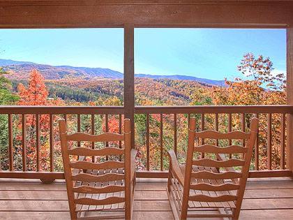 two chairs on a porch with a view of the mountains at Mountain Memories Holiday home in Gatlinburg
