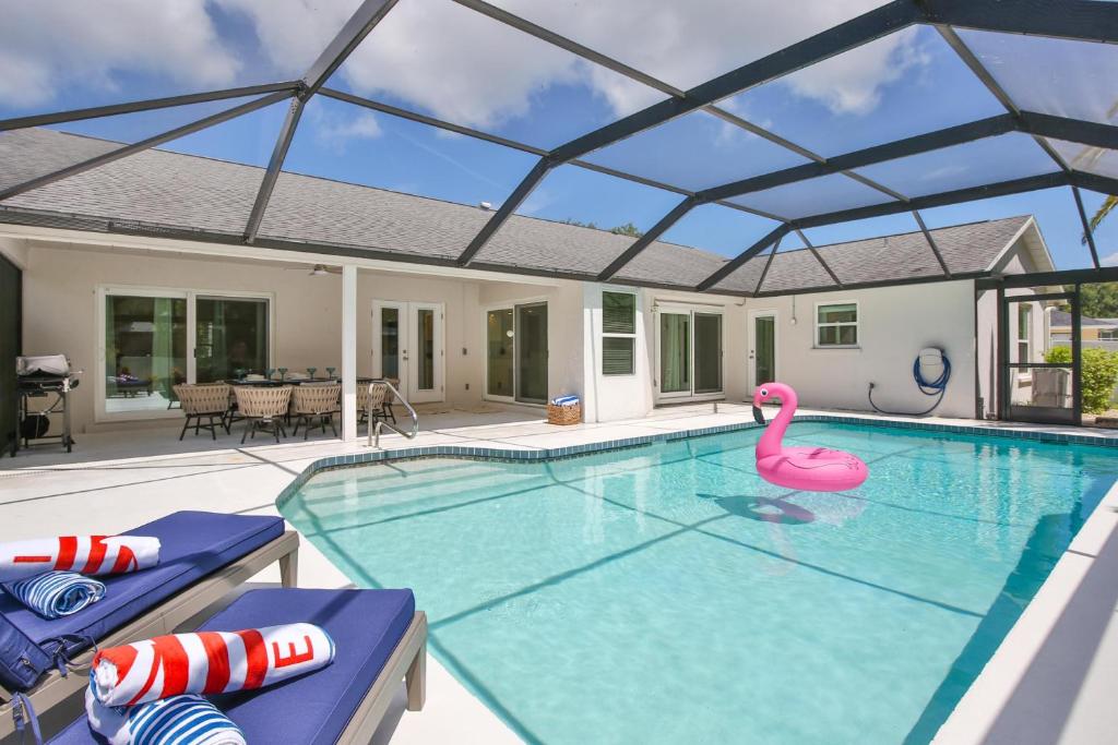 a swimming pool with a pink flamingo in a house at Florida Vibes in Bradenton