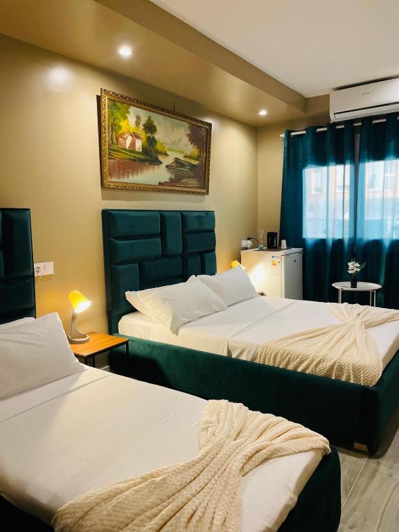 a hotel room with two beds and a window at AS ROOMS Alicante in Alicante