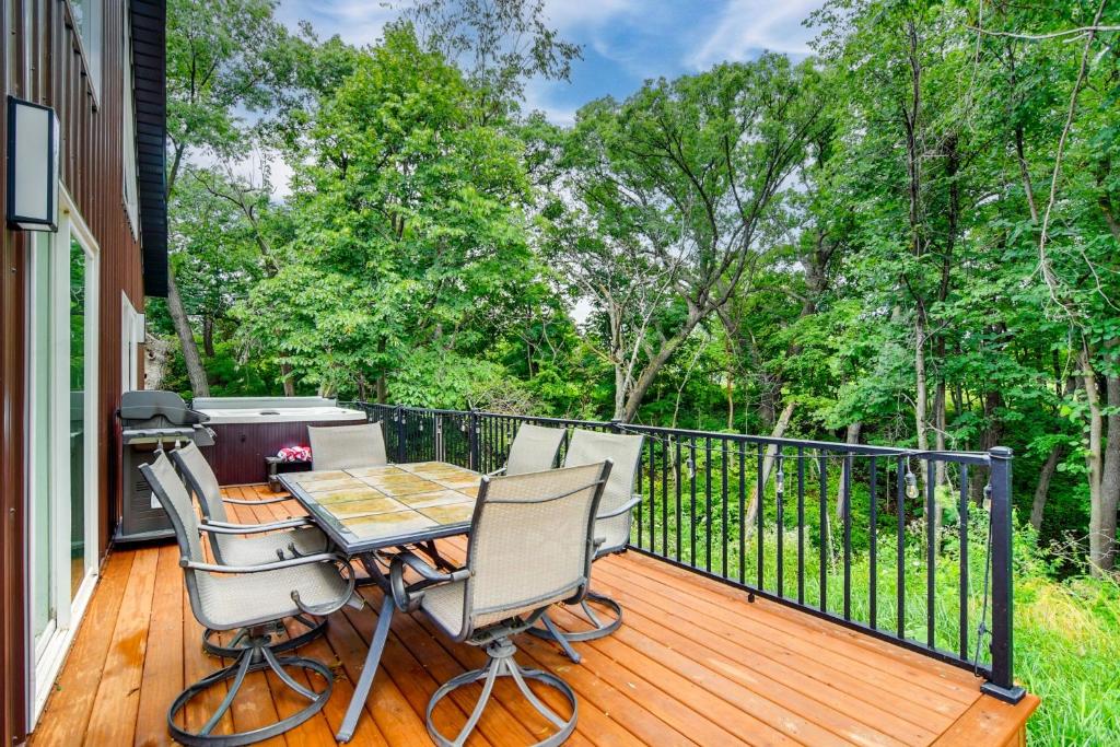 a patio with a table and chairs on a deck at Hot Tub, Water Access Cabin Near Lake Red Rock! in Knoxville