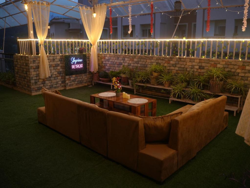 a living room with a couch and a table at The Mussoorie Glow in Dehradun