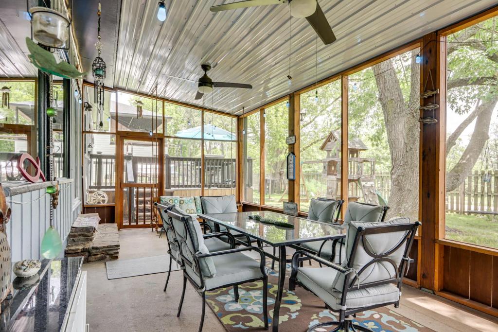 a dining room with a glass table and chairs at Walk to Lake Fayetteville Family Retreat with Deck in Springdale