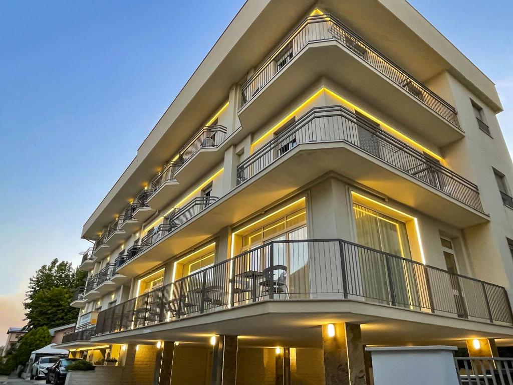 a large building with balconies on the side of it at Santa Barbara hotel & apartments in Bellaria-Igea Marina